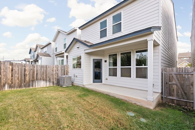 back of house with a patio, a lawn, fence, and central air condition unit