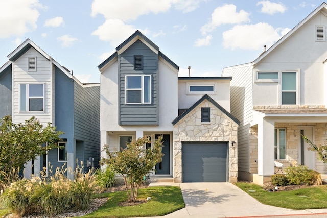 view of front of property featuring a garage, stone siding, and driveway