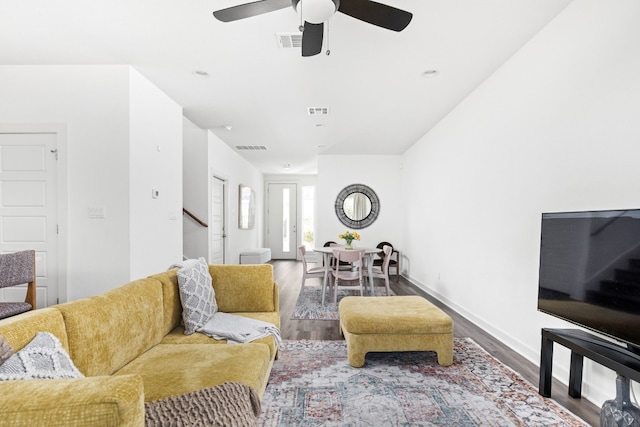 living room with visible vents, ceiling fan, and wood finished floors