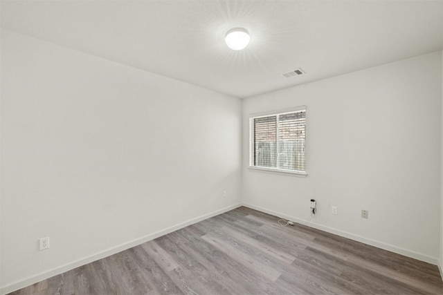 spare room featuring wood-type flooring