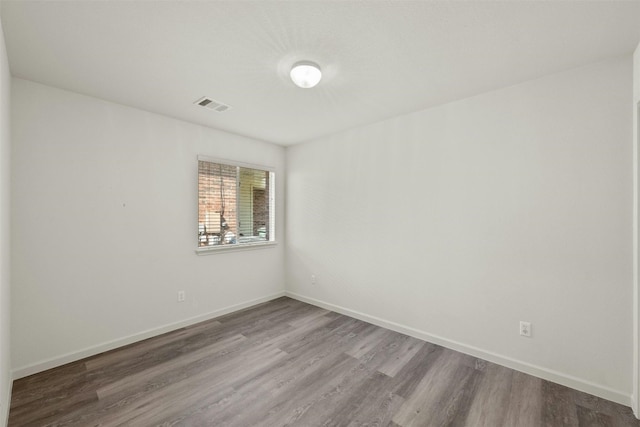 unfurnished room with wood-type flooring