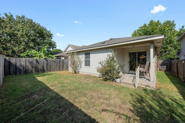 rear view of house featuring a patio and a lawn