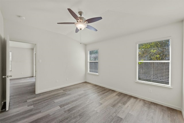 unfurnished room featuring light hardwood / wood-style flooring, ceiling fan, and vaulted ceiling