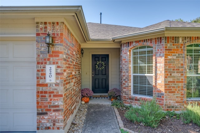 view of exterior entry with a garage