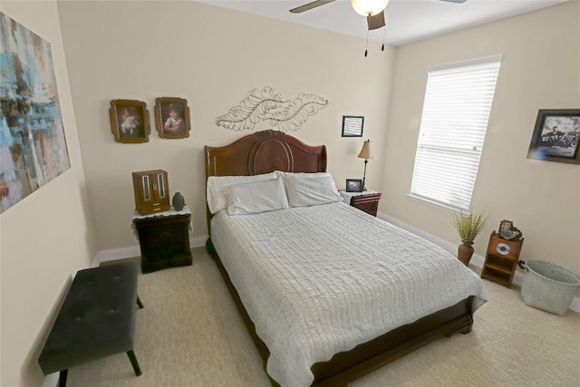 bedroom with ceiling fan and baseboards