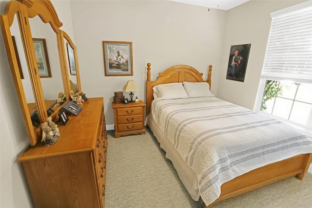 bedroom featuring light colored carpet