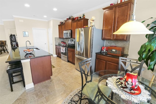 kitchen with a sink, ornamental molding, stainless steel appliances, dark countertops, and backsplash