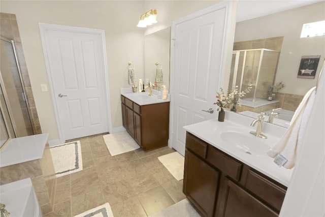 bathroom with two vanities, a tub to relax in, a stall shower, and a sink