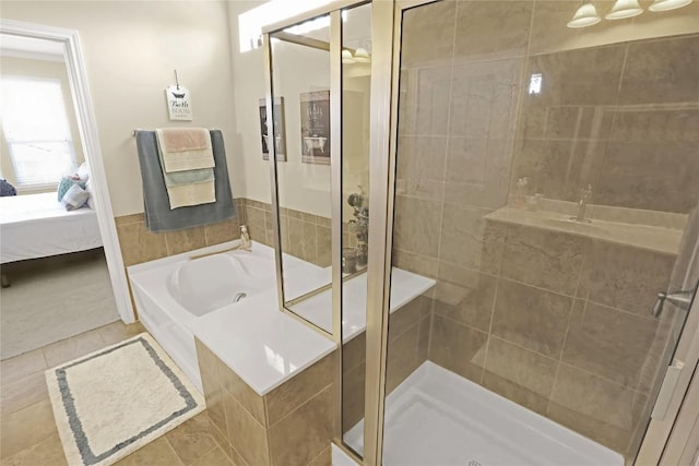 bathroom featuring ensuite bath, a stall shower, tile patterned flooring, and a bath