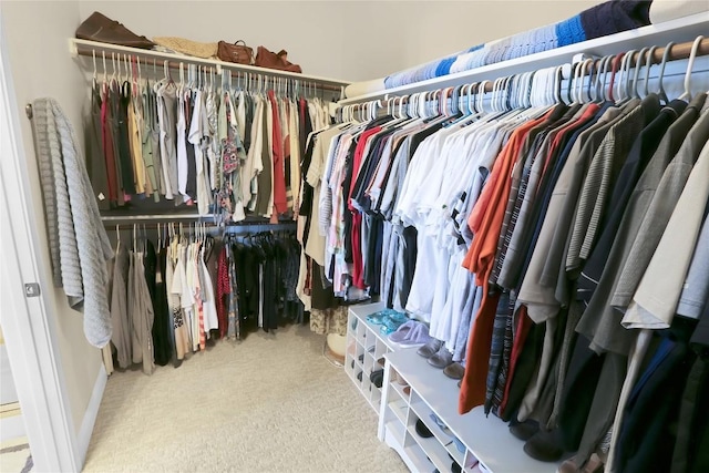 walk in closet with carpet flooring