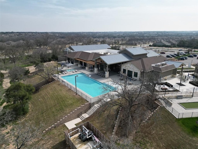 community pool featuring a patio area and fence