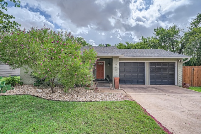 ranch-style home featuring a front yard and a garage