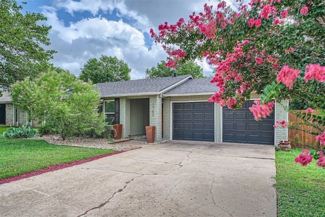 ranch-style home featuring a front yard and a garage