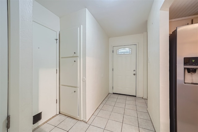 doorway with light tile patterned floors