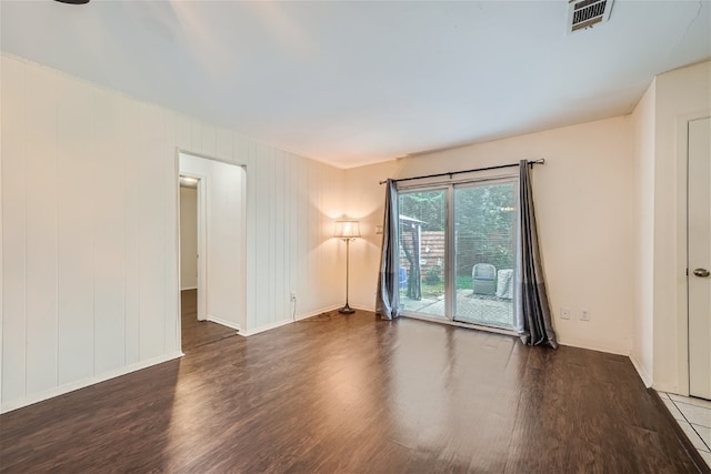 empty room featuring dark wood-type flooring