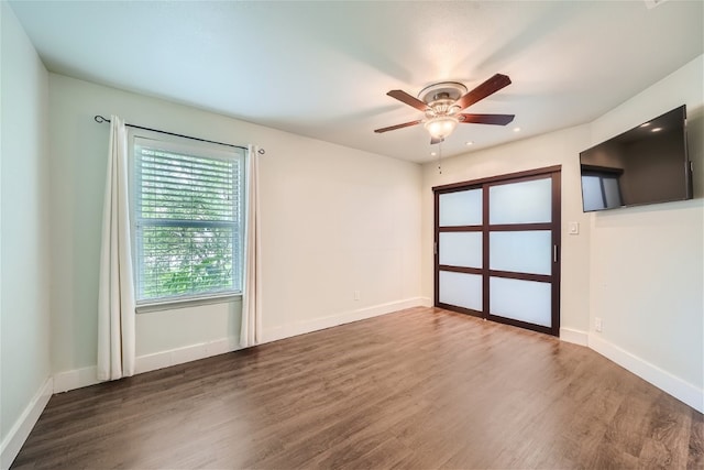 spare room featuring ceiling fan and dark hardwood / wood-style flooring