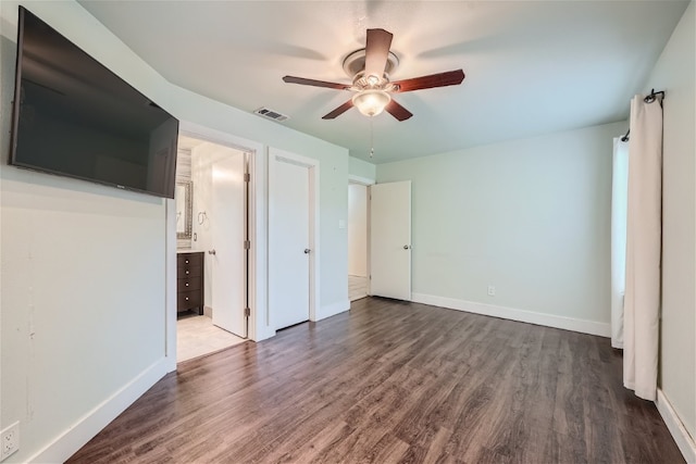 unfurnished bedroom with hardwood / wood-style flooring, ensuite bath, and ceiling fan