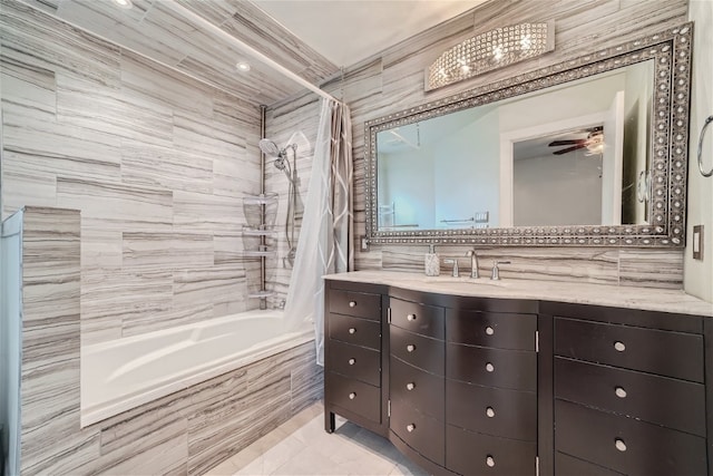 bathroom featuring ceiling fan, tile patterned floors, shower / tub combo with curtain, vanity, and tile walls