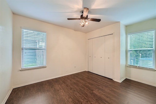 unfurnished bedroom featuring dark hardwood / wood-style flooring, a closet, and ceiling fan