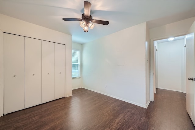 unfurnished bedroom with ceiling fan, a closet, and dark hardwood / wood-style floors