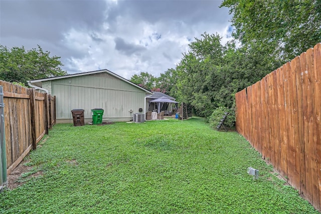 view of yard featuring a gazebo and central AC