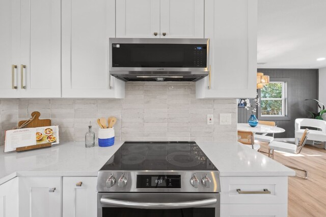 8000 Williamson Creek Dr, Austin, TX 78736 - kitchen with appliances with stainless steel finishes, light countertops, white cabinetry, and backsplash