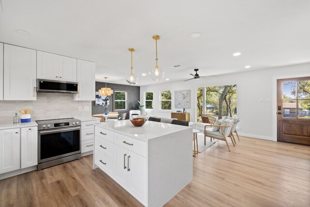 8000 Williamson Creek Dr, Austin, TX 78736 - kitchen featuring stainless steel appliances, recessed lighting, light wood-style flooring, light countertops, and a ceiling fan
