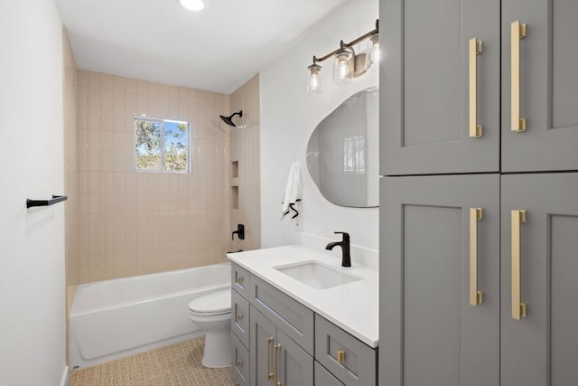 full bathroom with tile patterned floors, toilet, vanity, and tiled shower / bath