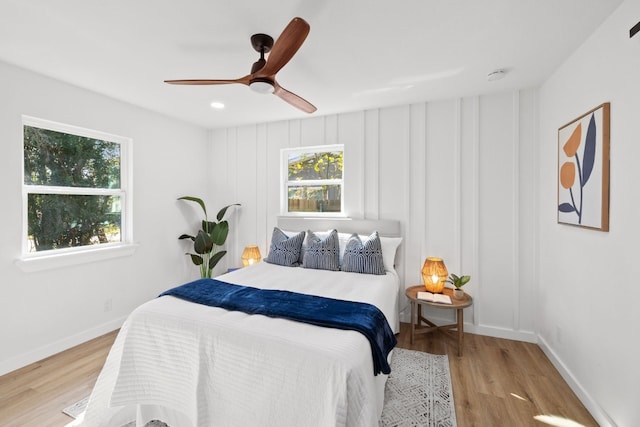 bedroom with light hardwood / wood-style floors and ceiling fan