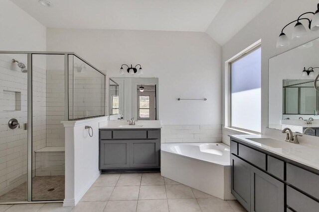 bathroom with shower with separate bathtub, vaulted ceiling, tile patterned floors, and plenty of natural light