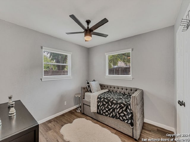 bedroom with ceiling fan and dark hardwood / wood-style floors