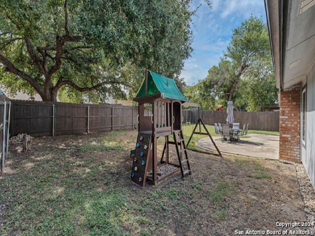 view of jungle gym featuring a patio