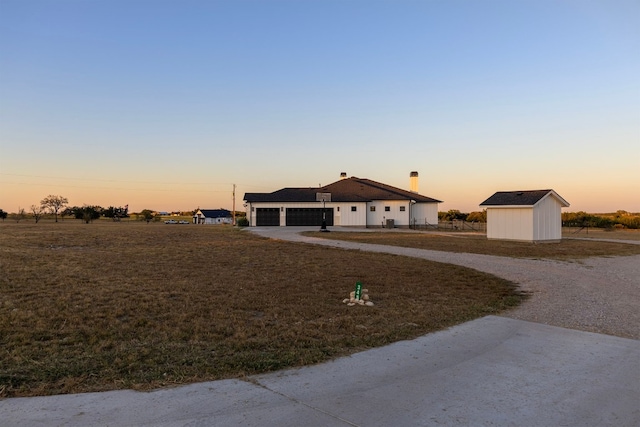 345 Judges Rd, Burnet, TX 78611 - ranch-style home with a garage, driveway, and a shed