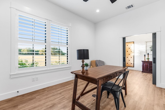 office space featuring ceiling fan and light hardwood / wood-style floors