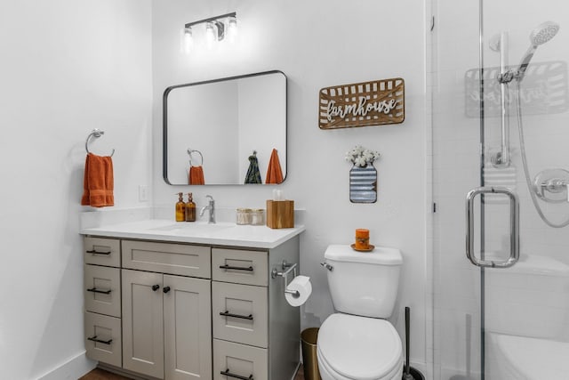 bathroom with vanity, an enclosed shower, and toilet