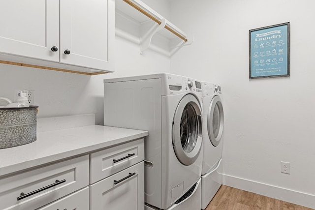 345 Judges Rd, Burnet, TX 78611 - laundry room featuring cabinet space, light wood-style flooring, and washing machine and clothes dryer