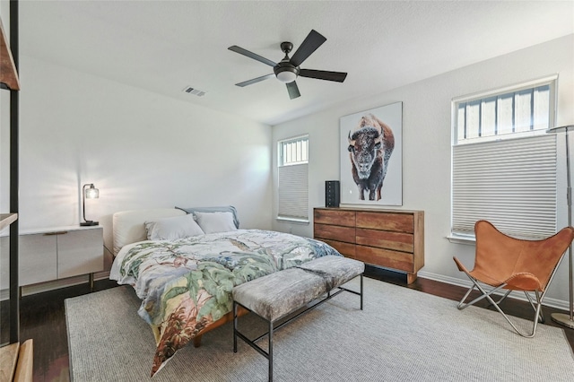 bedroom with ceiling fan and dark hardwood / wood-style flooring