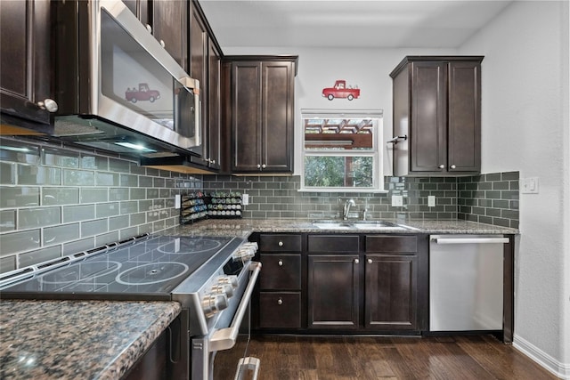 9904 Milla Cir Unit 33, Austin, TX 78748 - kitchen with stainless steel appliances, dark brown cabinetry, a sink, backsplash, and dark wood-style flooring