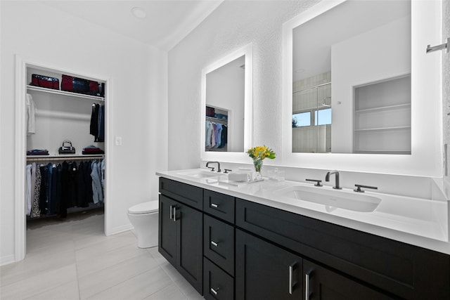 bathroom featuring walk in shower, tile patterned floors, vanity, and toilet