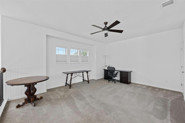 carpeted home office featuring visible vents and a ceiling fan