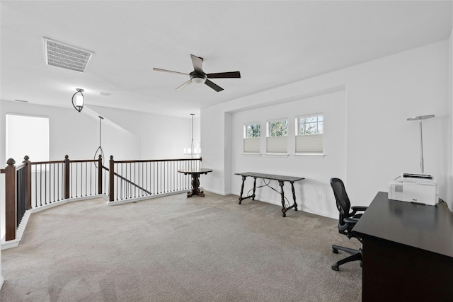 office featuring ceiling fan with notable chandelier and carpet floors