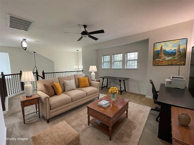 living room with visible vents, ceiling fan, and baseboards