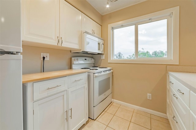 kitchen with white cabinetry, white appliances, and light tile patterned floors