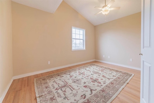 unfurnished room with ceiling fan, light hardwood / wood-style flooring, and vaulted ceiling