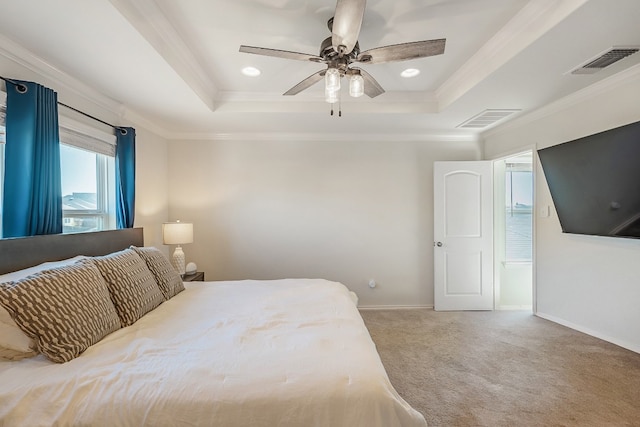 bedroom with a tray ceiling, ceiling fan, crown molding, and carpet floors