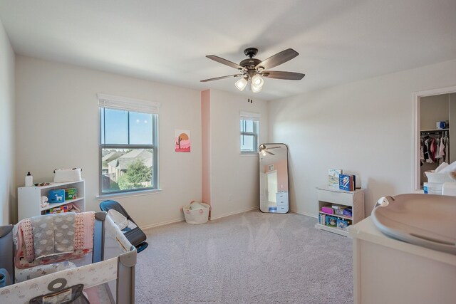 playroom with ceiling fan, light carpet, and plenty of natural light