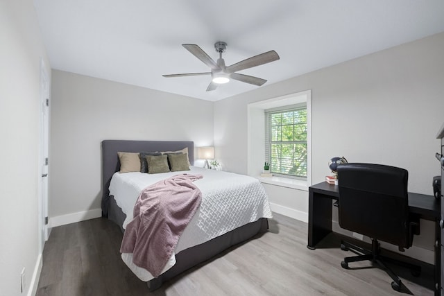 bedroom with hardwood / wood-style floors and ceiling fan