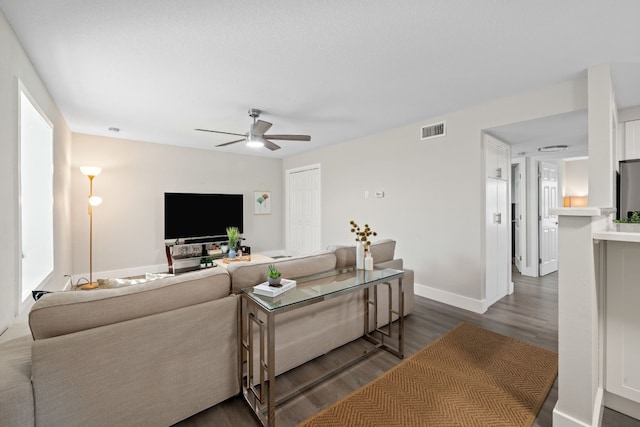 living room featuring dark hardwood / wood-style floors and ceiling fan