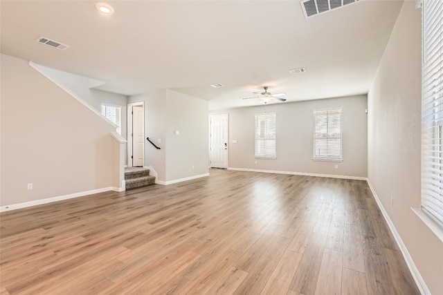 196 Lost Mine Peak Ln, Dripping Springs, TX 78620 - unfurnished living room featuring light wood-style flooring, a ceiling fan, stairway, baseboards, and recessed lighting