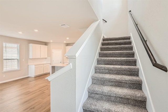 196 Lost Mine Peak Ln, Dripping Springs, TX 78620 - stairs featuring wood finished floors, recessed lighting, and baseboards